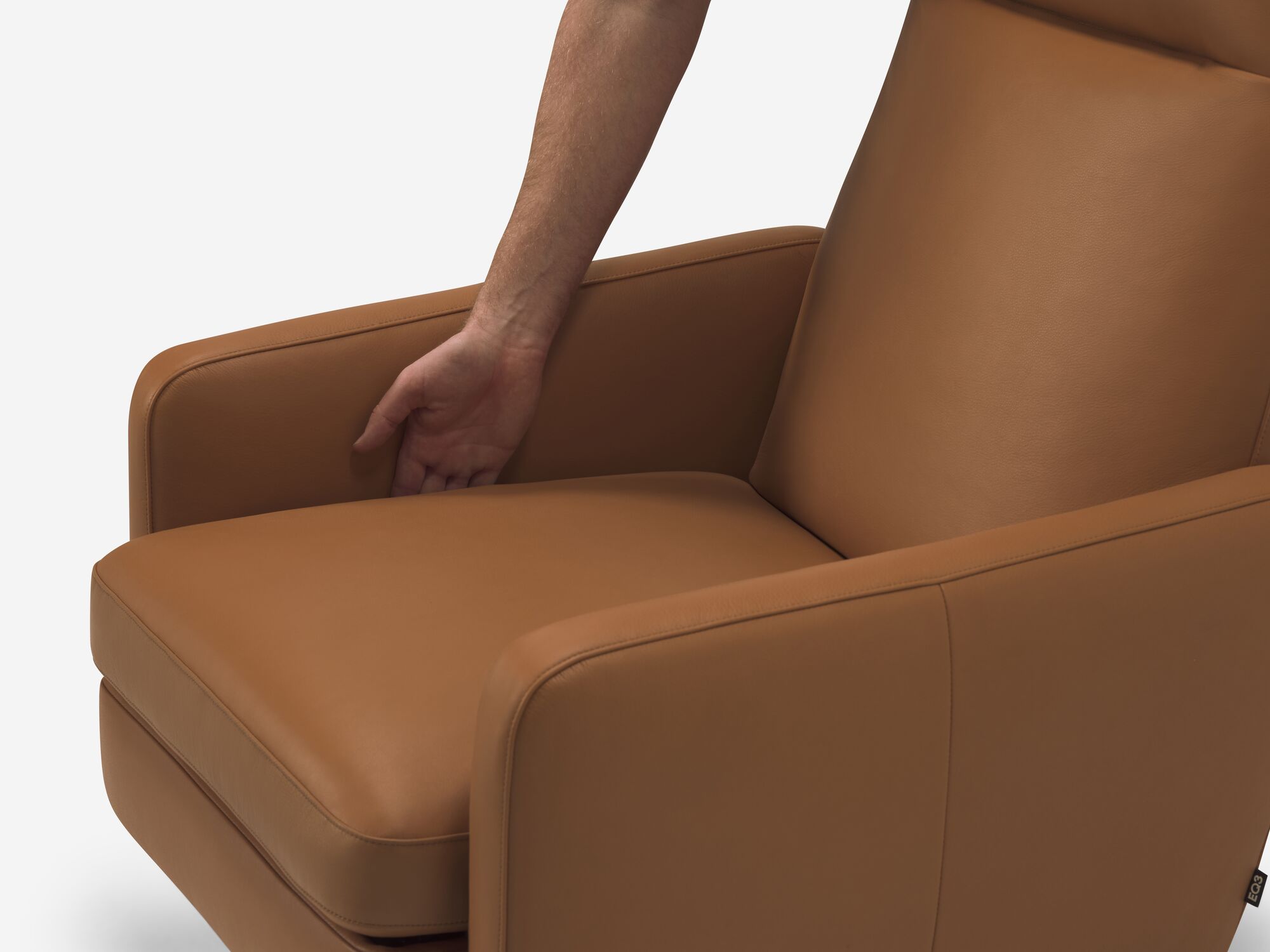 Seat detail view of brown leather reclining chair with hand operating reclining mechanism